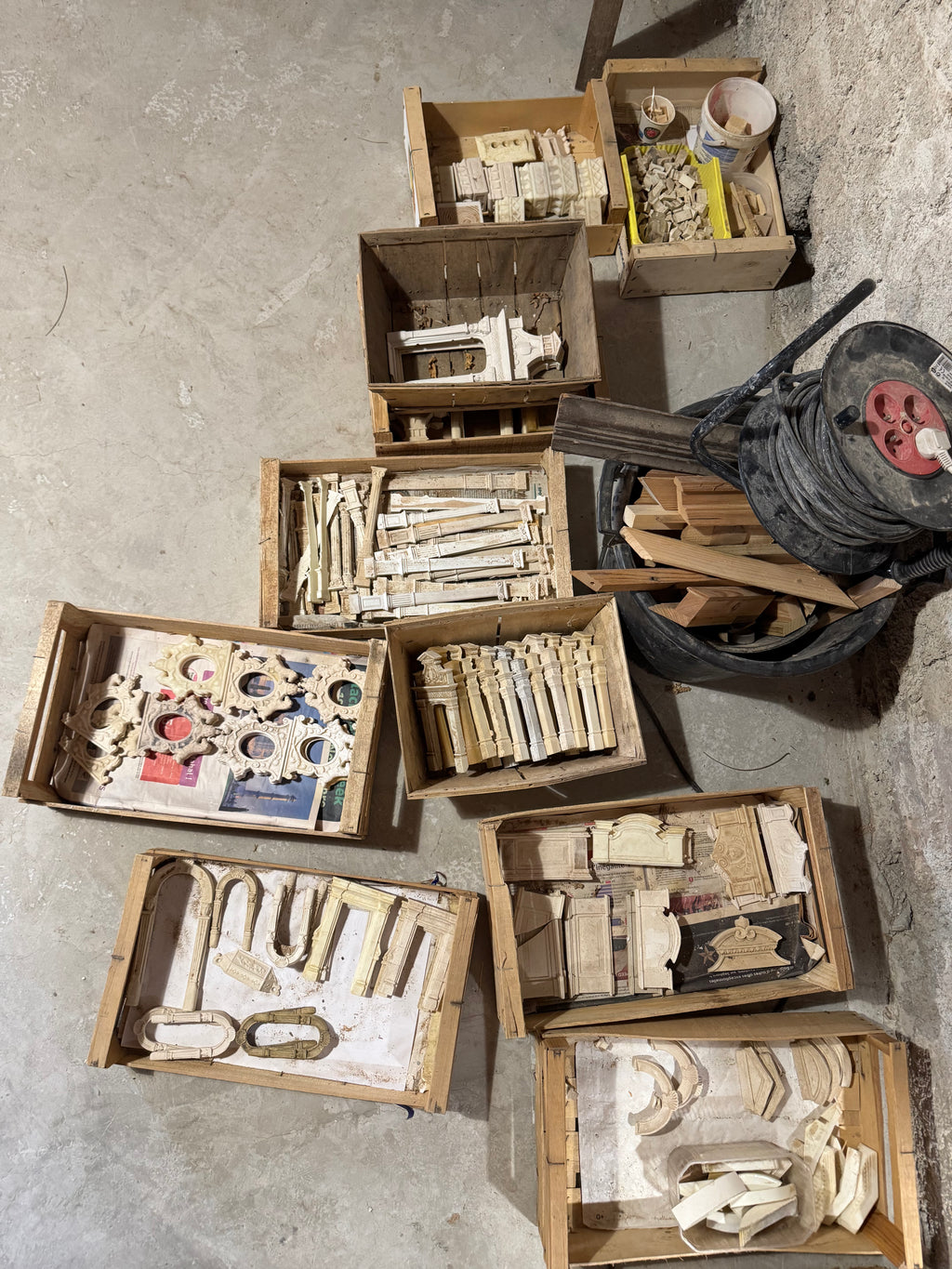 Wooden archive trays filled with miniature columns, mouldings, plaques and plaster castings from fifty years of architectural craft at Lansdown Arts