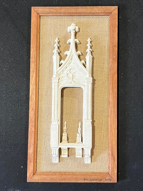 Close frontal view of Architectural Archive No. 07 showing its Gothic portal, pointed tracery and carved plaster ornament within a wooden frame
