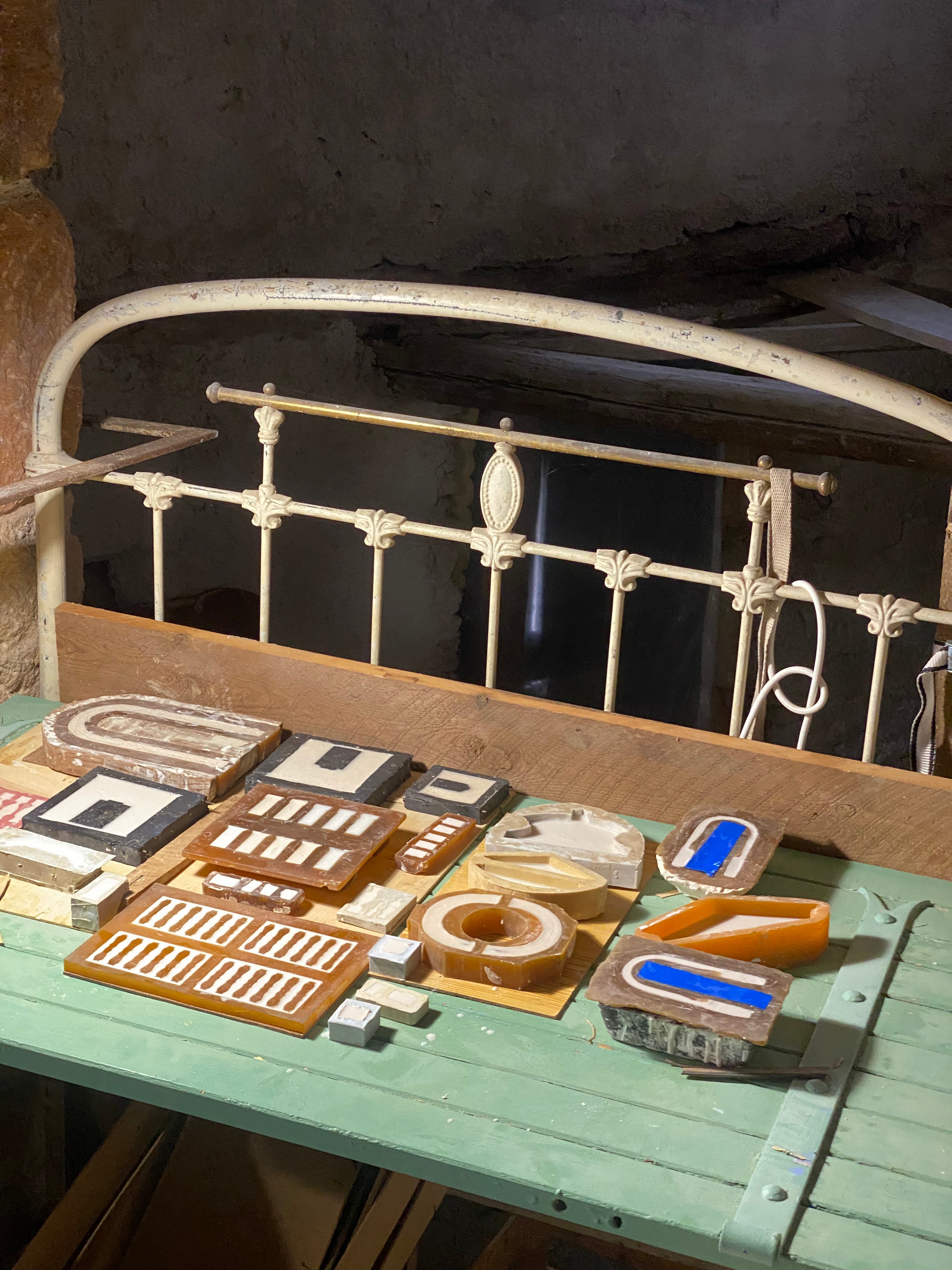 Assorted plaster and resin architectural castings, including balustrades, doorways and geometric ornaments, arranged for composition in the Lansdown workshop