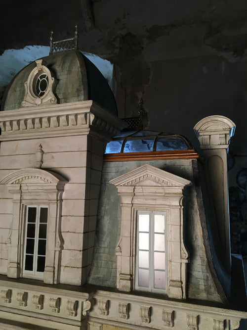 Curved glass mansard roof, oval dormer and classical window surrounds on the handmade Whitestone architectural dollhouse.